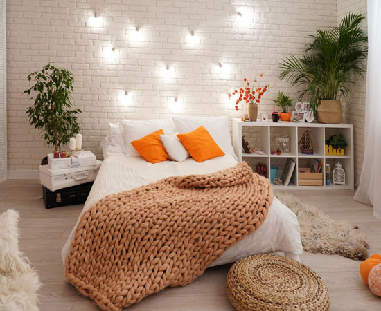 Decorated bedroom with orange cushions