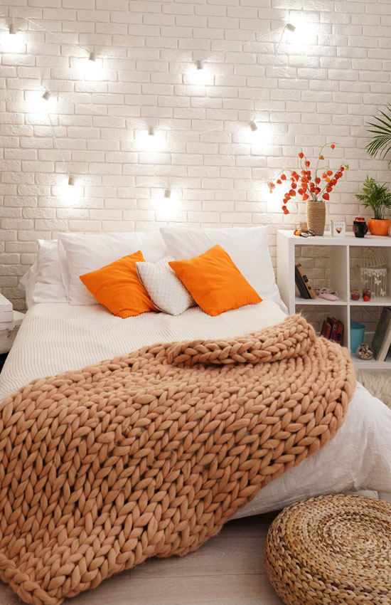 Soft lit bedroom with textured blanket
